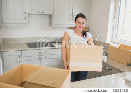 Young woman unpacking Young woman unpacking 6831980