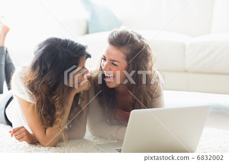 Two laughing women with a computer Two laughing women with a computer 6832002
