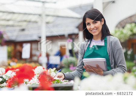 Employee taking notes in garden centre 6832172