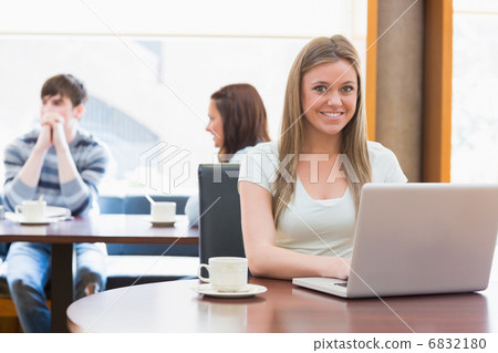 Girl sitting at the college coffee shop with laptop Girl sitting at the college coffee shop with laptop 6832180