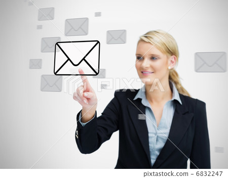 Businesswoman standing while touching email symbol 6832247