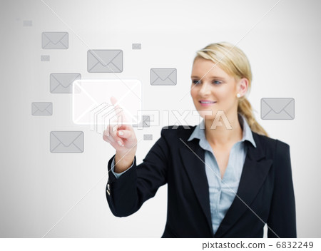 Businesswoman touching email symbol Businesswoman touching email symbol 6832249