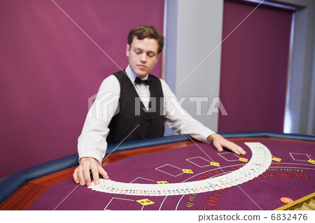 Dealer spreading deck of cards 6832476