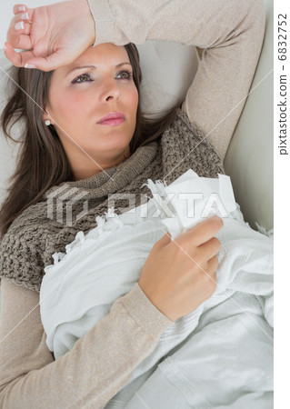 Ill woman lying on sofa Ill woman lying on sofa 6832752