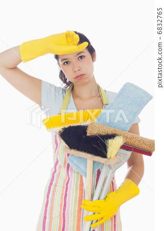 Tired woman holding cleaning tools 6832765
