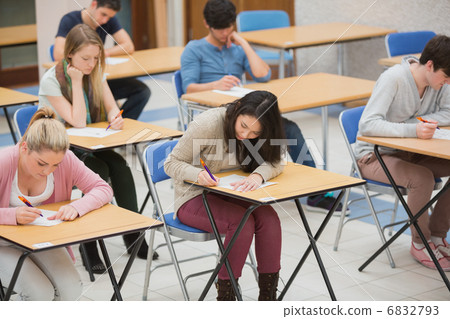 Students writing in the exam hall Students writing in the exam hall 6832793