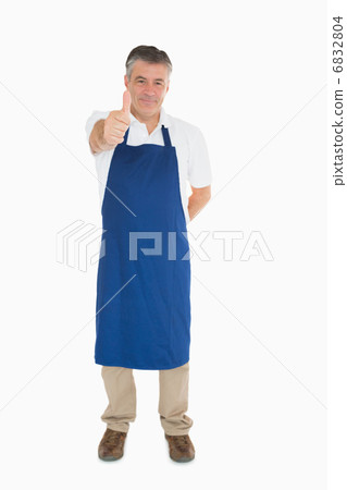 Man in apron giving thumbs up 6832804