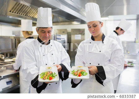 Two Chefs presenting their salmon dishes 6833387