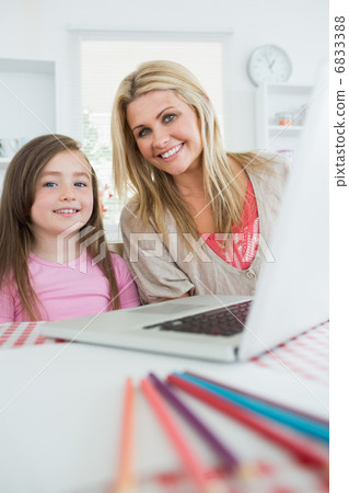 Mother and girl are smiling at the kitchen Mother and girl are smiling at the kitchen 6833388