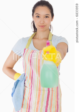 Woman spraying cleaner 6833959