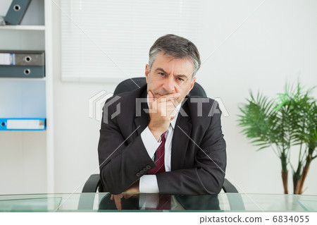 Businessman looking thoughtfully Businessman looking thoughtfully 6834055