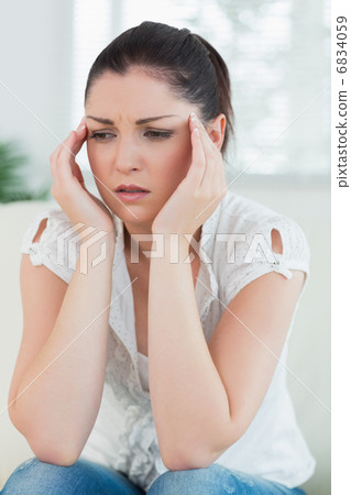 Stressed woman sitting on the couch Stressed woman sitting on the couch 6834059