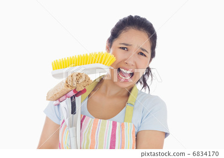 Frightened woman holding mop and a broom 6834170