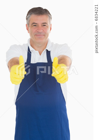 Man wearing apron giving thumbs up 6834221