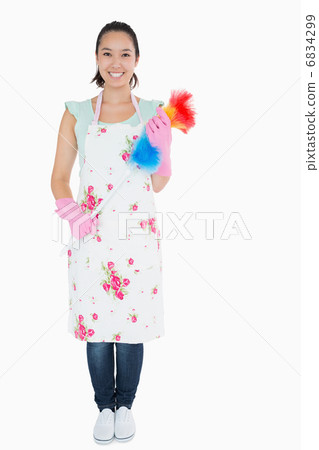 Woman standing with duster 6834299
