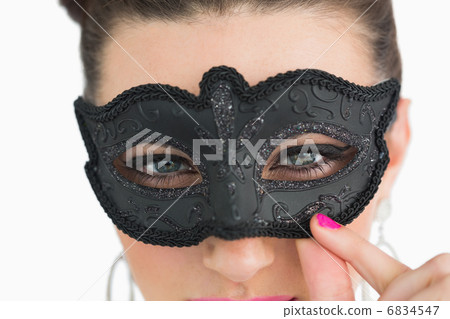 Woman wearing masquerade mask 6834547