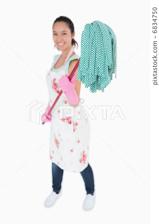 Woman holding a mop with gloves on 6834750
