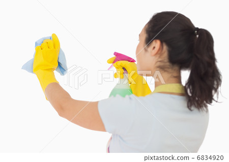 Woman spraying and wiping in rubber gloves Woman spraying and wiping in rubber gloves 6834920