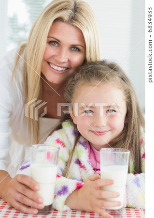 Mother and girl drinking milk Mother and girl drinking milk 6834933