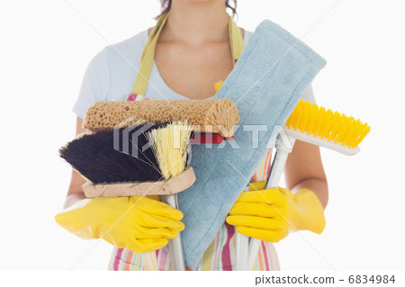 Woman holding brushes and mops 6834984