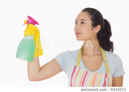 Young woman spraying cleaner 6835013