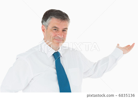 Smiling businessman holding out his hand Smiling businessman holding out his hand 6835136