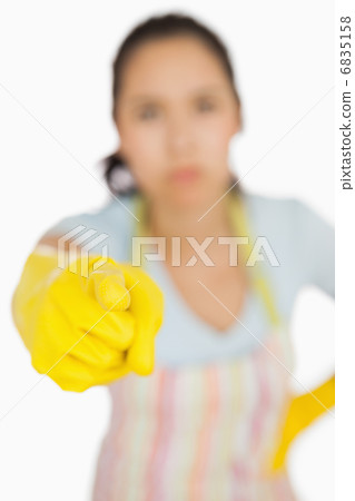 Woman in apron pointing accusingly 6835158