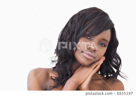 Woman holding hands at cheek Woman holding hands at cheek 6835197