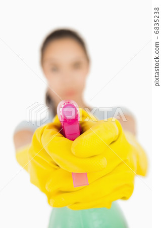 Confident woman pointing a spray bottle at the camera Confident woman pointing a spray bottle at the camera 6835238