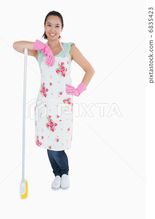Woman leaning on a broom 6835423