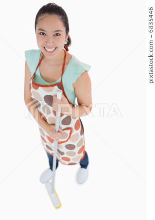 Happy woman sweeping the floor 6835446