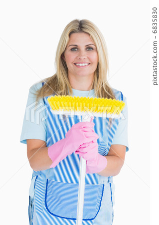Cleaner woman holding a broom 6835830