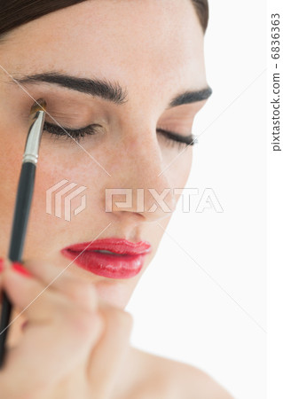 Woman applying makeup 6836363