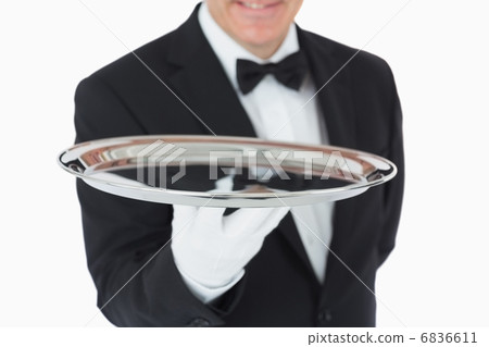 Smiling man holding a silver tray 6836611