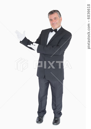 Man showing us something against white background Man showing us something against white background 6836618