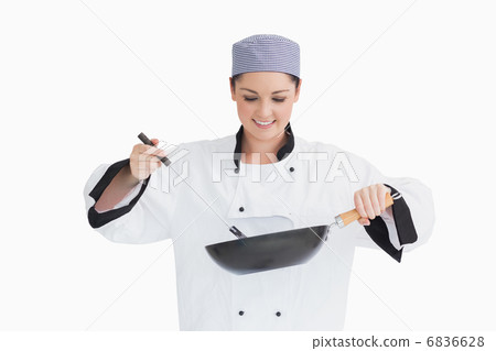 Cook cooking with wok and spoon 6836628