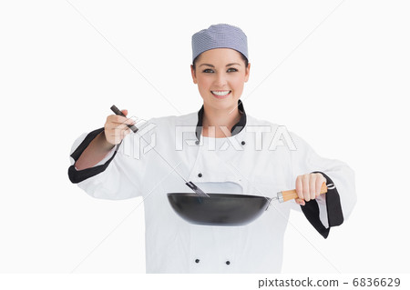 Happy cook cooking with wok and spoon 6836629