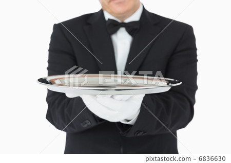 Man holding a silver tray with both hands 6836630