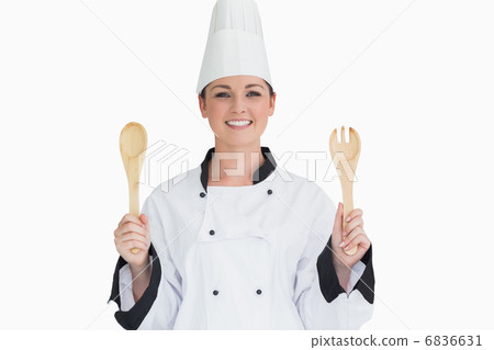Cook holding wooden salad tosses 6836631