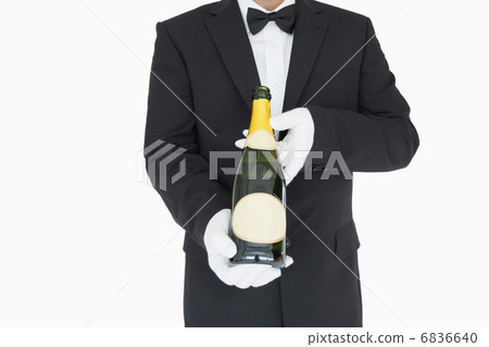 Waiter holding champagne bottle Waiter holding champagne bottle 6836640