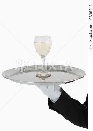 Glass of wine on tray Glass of wine on tray 6836641