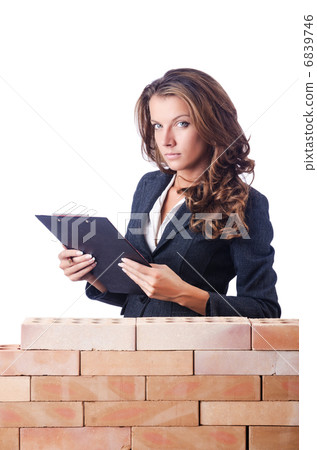 Woman builder and brick wall Woman builder and brick wall 6839746
