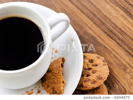 Coffee and oatmeal cookies on wooden table Coffee and oatmeal cookies on wooden table 6844975