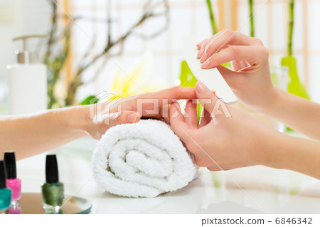 Woman in nail salon receiving manicure 6846342