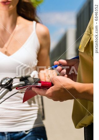 Police - woman on bicycle with police officer 6846352