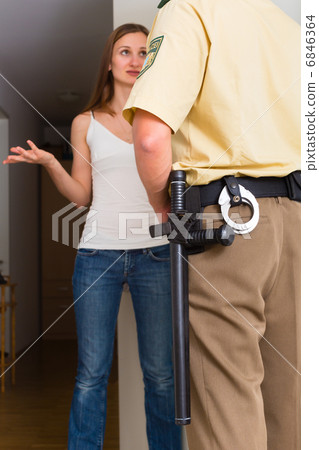 Police officer interrogation woman at front door 6846364