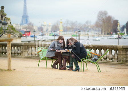 Tourists in Paris planning their trip using map 6848955