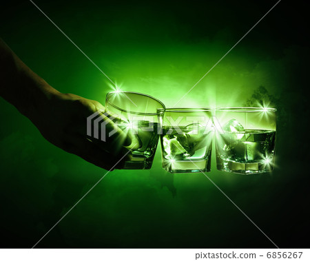 Three glasses of green absinth with ice cubes 6856267