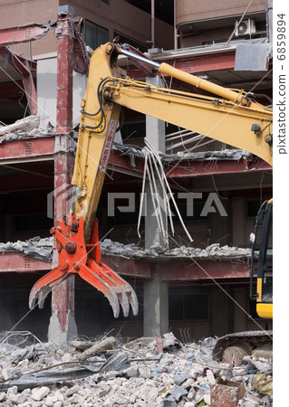 Dismantling work of the building by heavy machinery Dismantling work of the building by heavy machinery 6859894