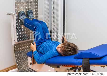Child is therapeutic exercises in the gym 6860781